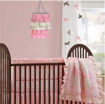 Pink and brown baby girl nursery room decorated with DIY crafts projects and curtains