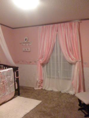 Pink and white striped nursery curtains.  Full length panels tie back to let in natural light. 