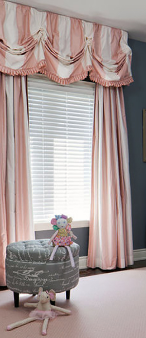 Elegant pink and white striped curtain panels with window valance with pleated edging. Curtain panels with wide pink and white stripes