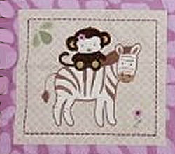 Pink and brown zebra and monkey theme crib quilt for a baby girl nursery room