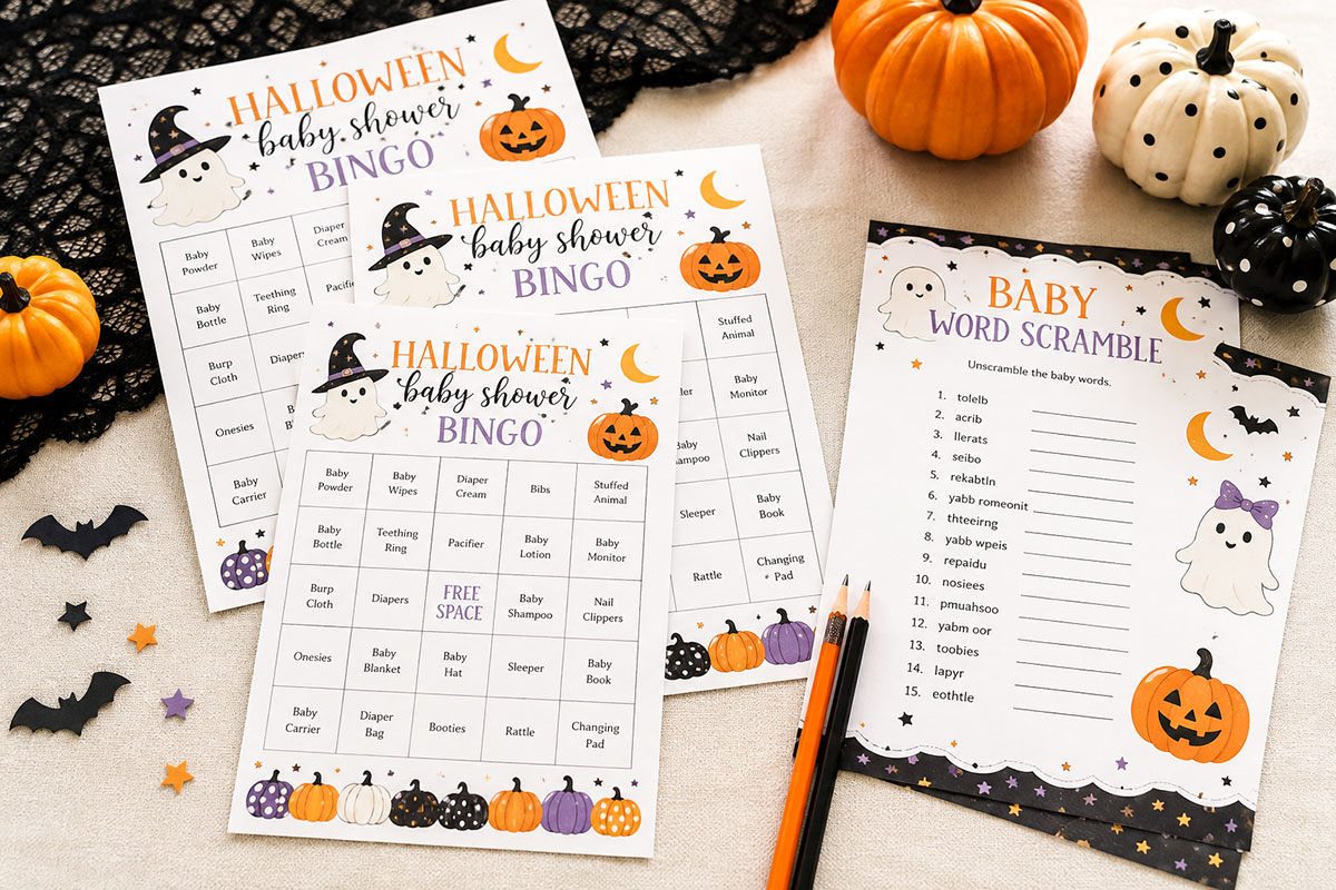 Printable Halloween baby shower bingo cards and baby word scramble sheets arranged with pencils and small pumpkin decorations