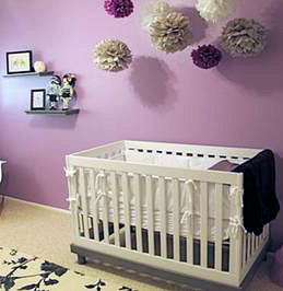 Modern urban style purple and black baby girl nursery with a tattoo theme and crib set