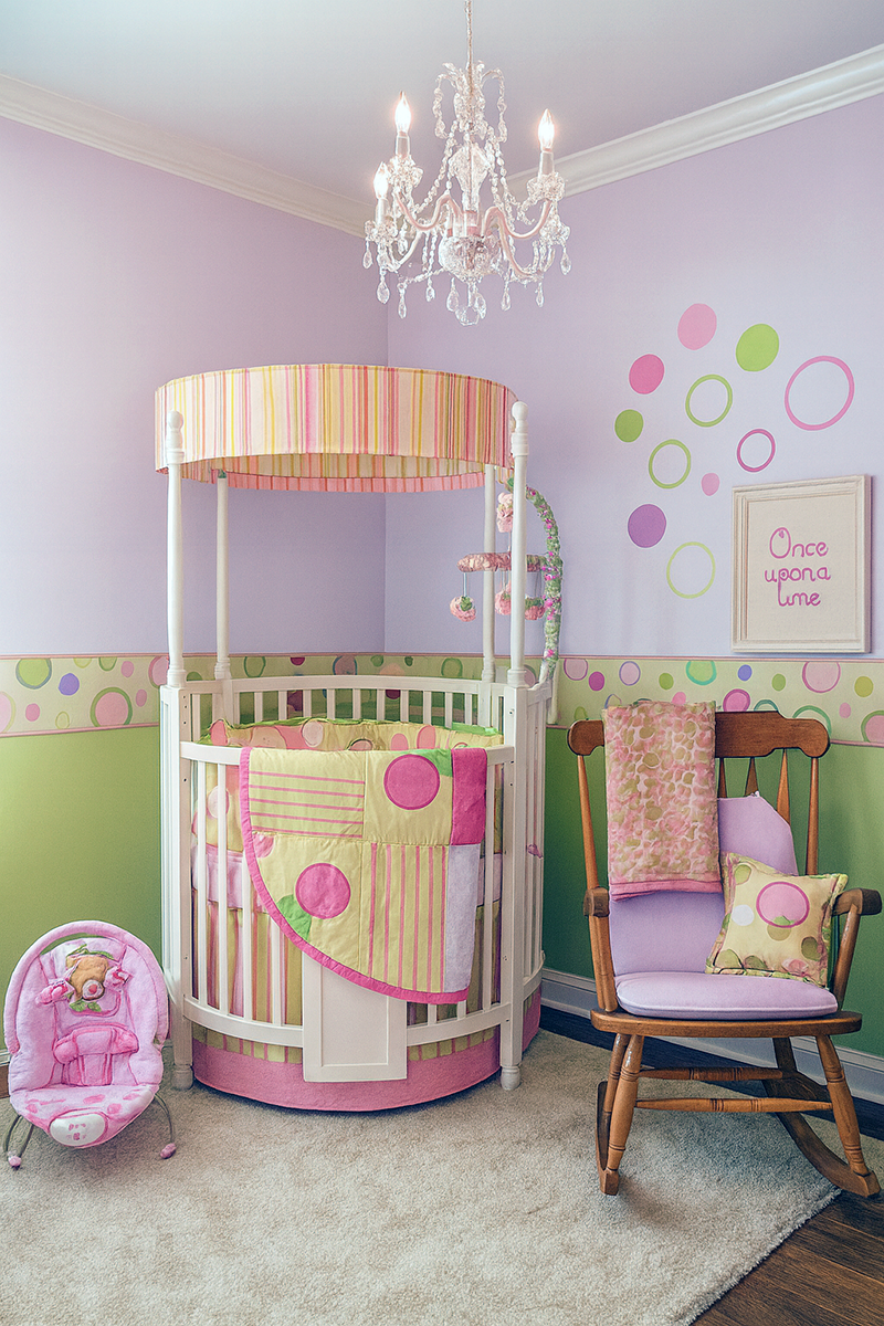 Round princess crib nursery with pink and lime green decor