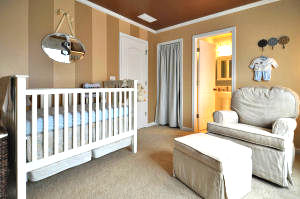 Painted wall stripes in a baby boy nursery in shades of brown