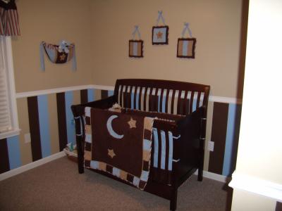 Chocolate brown and blue baby boy nursery room decorated in a moon stars and stripes theme