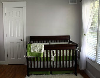 Serene gender neutral nursery design in white, gray and green.