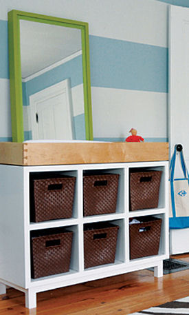 Modern white baby diaper changing table area in a blue and white nursery for a baby boy