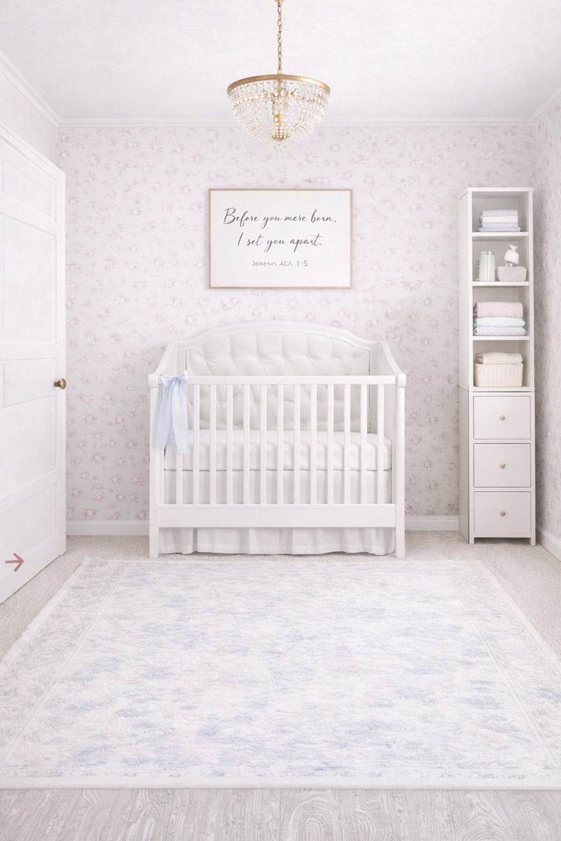 Small 8x10 nursery layout with a standard crib, slim vertical storage, in a soft blush-and-cream palette with a small-pattern wallpaper and rug