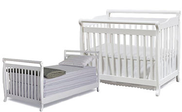 White foldable convertible baby crib perfect for a small nursery room