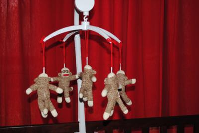 Homemade sock monkey baby crib mobile made to match a custom nursery bedding set