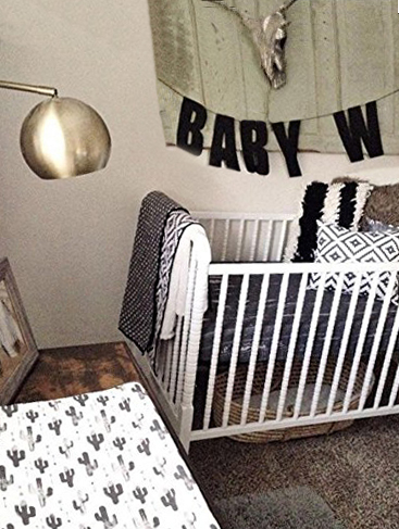 Gender neutral southwest cactus baby nursery ideas with black cactus and western desert accessories and crib bedding for a boy or girl