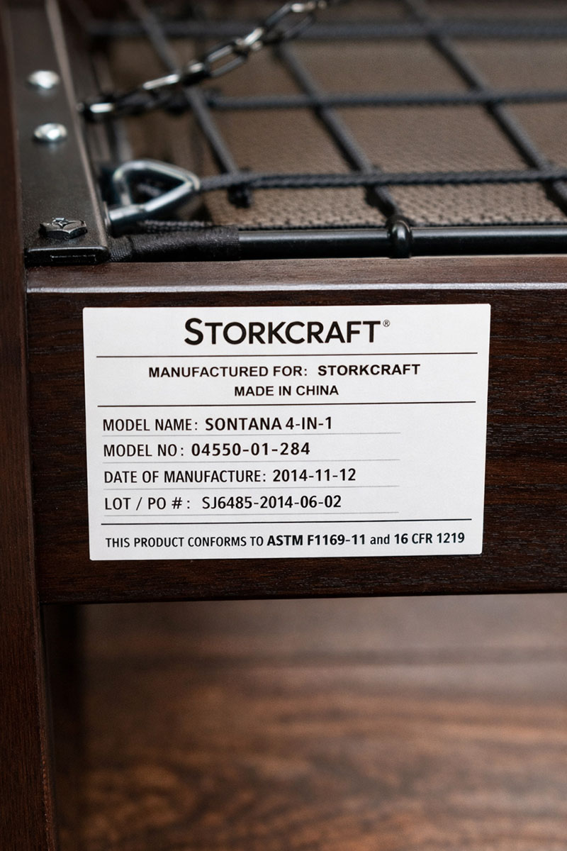 Storkcraft crib manufacturer label showing model number and production information on the crib frame
