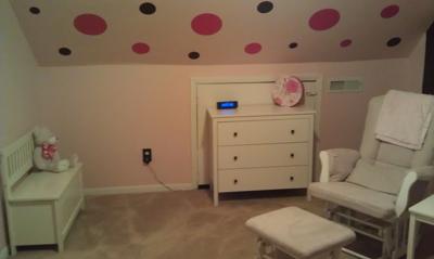 Hot pink and chocolate brown wall decals on the sloped part of the nursery ceiling.
