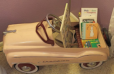 vintage pink baby girl pedal car bookshelf nursery decor