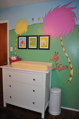 The baby's nursery wall is painted with a colorful Lorax tree mural  based on the Dr Seuss book.