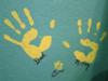 Handprints Left by Mommy, Daddy and a Puppy Dog Paw Print on the Nursery Wall.