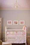 Baby girl nursery with blue gray walls made feminine with a pretty pink ceiling.