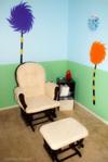 Dr. Seuss Truffula Trees Nursery behind our nursery glider rocker and ottoman.