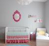 Pops of bright fuchsia pink in this baby girl's nursery are the perfect complement for the soft, grey nursery wall paint color.