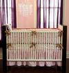 A modern boho crib set for a baby girl with vintage Moroccan influence 