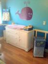 Purple whale nursery wall decal over the baby's changing table dresser combo. Ocean Wonders Diaper Stacker, Sea Babies Hamper