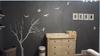 A wall decal featuring a tree with no leaves in winter with flying birds in our baby boy's nursery room.   