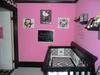 Our baby girl's nursery has a bold hot pink wall paint color that contrasts with the black and white baby crib bedding set and punk nursery theme.