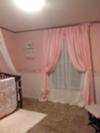 Pink and white striped nursery curtains.  Full length panels tie back to let in natural light. 