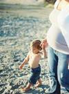 Beach maternity photo shoot.  The picture of the pregnant mom with her little boy walking on the sand is so perfect that I can almost taste the salty air and feel the sunshine on my skin.