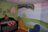 The Wizard of OZ nursery mural, the mobile, the poppy canvases, and her crib