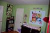 Another Wizard of Oz mural over the changing table featuring the main characters  and a view of the rest of  the nursery.