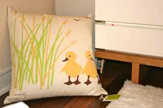 The yellow ducky pillow that was the perfect inspiration piece for my baby's tranquil modern nursery design.