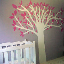 White painted tree with pink leaves on the wall of a baby girl nursery