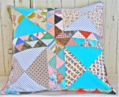 Vintage heirloom patchwork quilt pillows are perfect for a nursery rocking chair in an old-fashioned baby nursery.