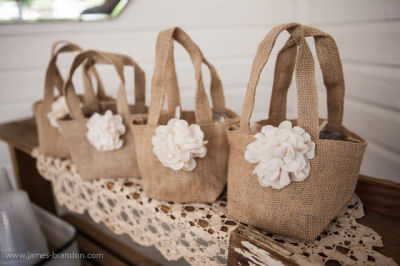Burlap baby shower favor treat bags are filled with prizes for winners of games