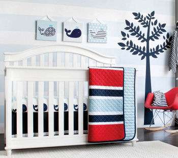 Baby boy whale nursery décor with blue whales white crib and baby blue and white wall painting technique