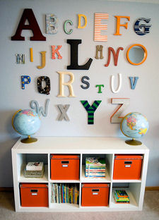 Orange fabric bins used as baby nursery storage containers