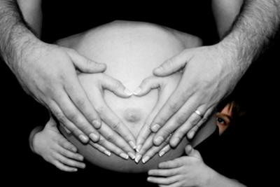 Black and white pregnant belly picture with Mom's, Dad's and baby's big brother's heart shaped hands joined over my tummy!  This baby boy was worth the wait!