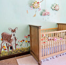 Nature themed baby girl nursery room with a deer wall mural