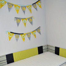 Yellow gray lime green navy blue and black montessori nursery with baby name wall banner