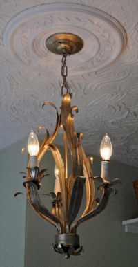 Original antique ceiling light fixture circa 1900 in the nursery of The Davis House Craftsman Style home