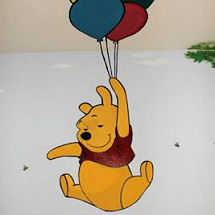 Winnie the Pooh baby nursery with bright painted wall murals