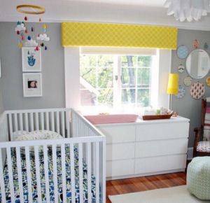 Gray and yellow baby nursery with bright accent colors and white trim.