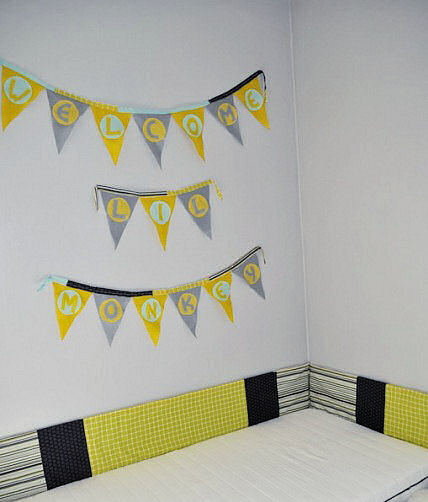 Charming gray, yellow and white felt wall banner made for a baby shower now decorates the wall of the nursery