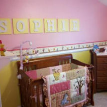 Baby girl Winnie the Pooh nursery with the baby's name in yellow and white wooden wall letters