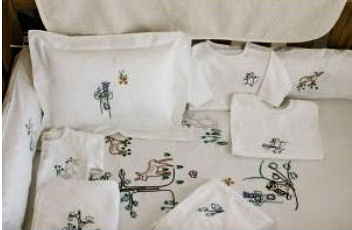 Coyuchi Thor Neutral Organic Baby Crib Bedding Set in a Forest Theme with Wild Woodland Creatures including Baby Deer and other animals