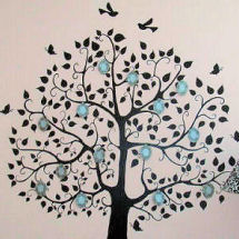 Family tree nursery wall decals decorated with 3D framed black and white photos on a pink wall