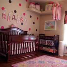 Pink tan and chocolate brown baby girl nursery decorated with polka dots