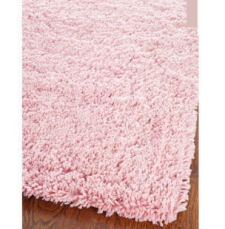 Round pink shag rug for a baby girl nursery room or teen girl bedroom.