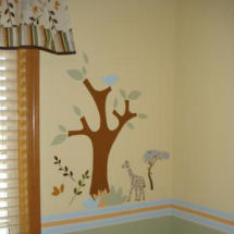 Jungle safari theme baby nursery wall mural with African trees giraffes and leaves